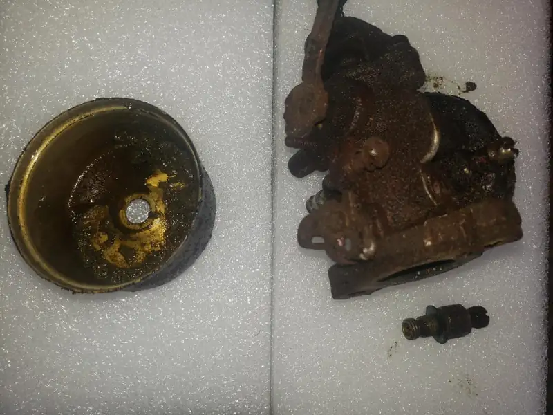 A float bowl coated in fuel varnish.