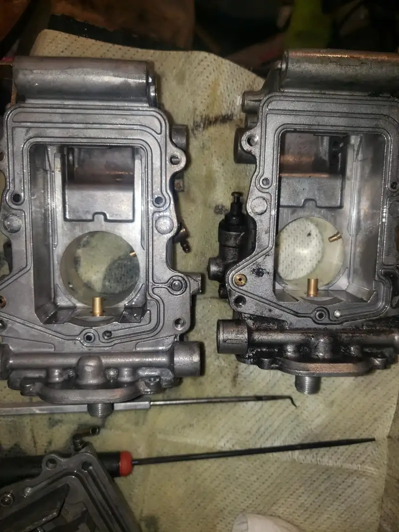 Two carburetors on a shop towel.