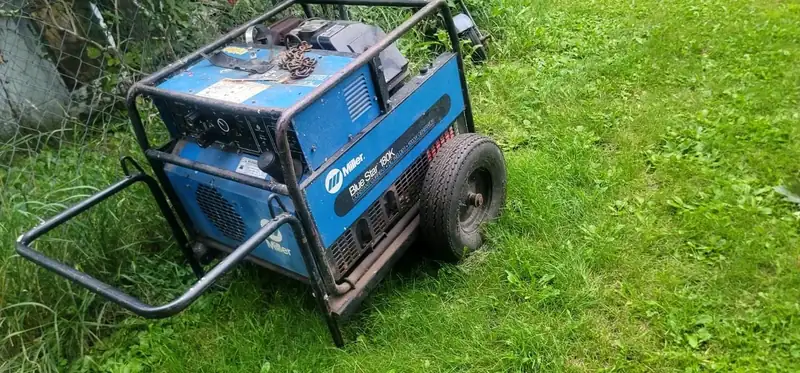 A Miller Blue Star welder-generator on the grass.