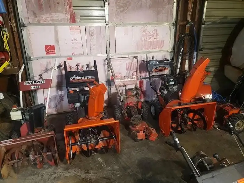 Mowers and snowblowers in the bay at S & M Small Engine Repair, Merrill, Wisconsin.