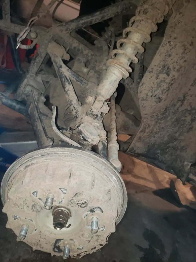 A UTV rear end apart on the shop floor. No plate in the frame.